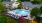 a swimming pool in a courtyard with lounge chairs